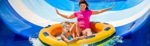Mom and daughter in an inner tube on a water slide