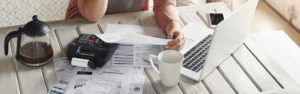 woman with her laptop reviewing her finances at home