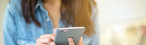 Young woman holding her mobile phone