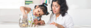 mom and child counting money from a jar