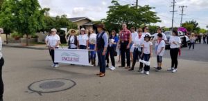 UNCLE staff walking in parade