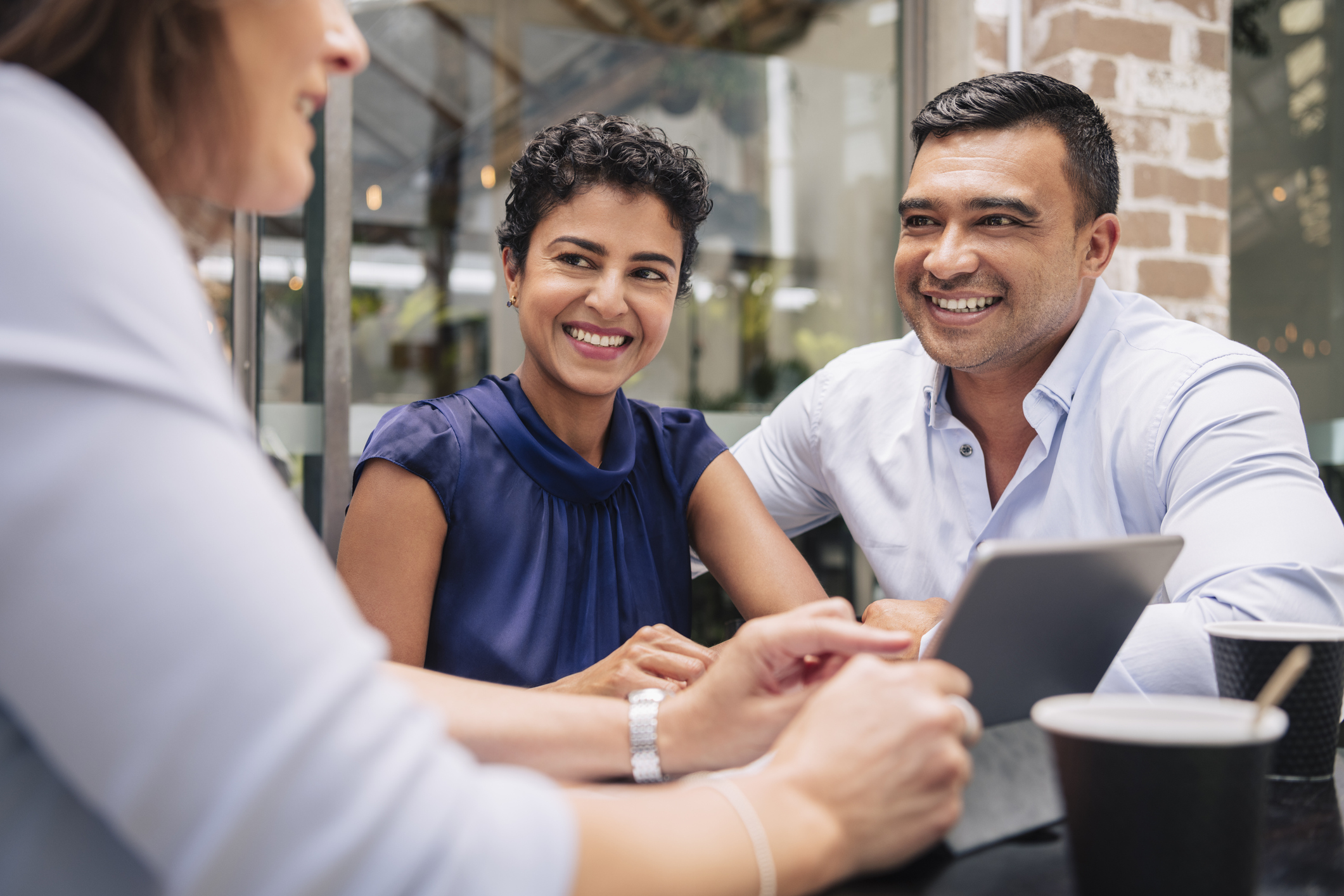 Happy couple receive good news from professional businesswoman Happy couple receive good news from professional businesswoman