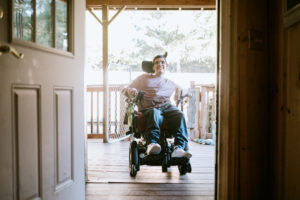 Young Man In Wheelchair At Home