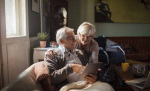 Close up of a senior couple using a tablet at home