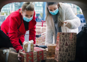 Women packing trunk with gifts during COVID