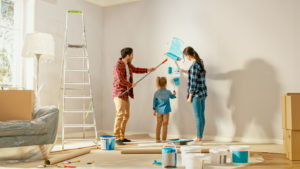 Family painintg wall in home together