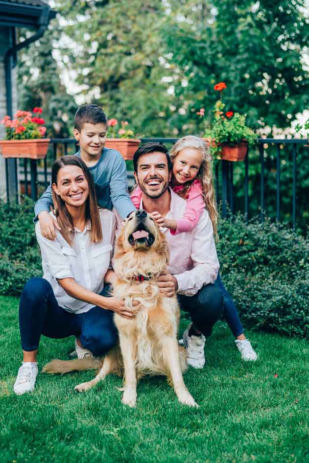 Portrait of happy family with their dog.
