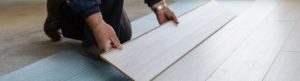 Worker carpenter doing laminate floor work