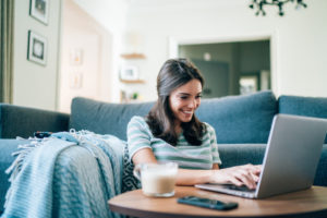 Woman connected on her laptop at home