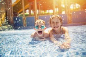 Brother and sister having fun in water park