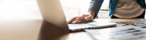 Person working and typing on Laptop in the office. Banner and Panoramic with copy space.