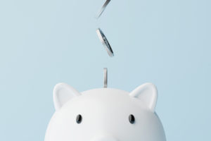 Closeup piggy bank and silver coins falling. 3d rendering illustration