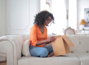 African American woman unpacking parcel