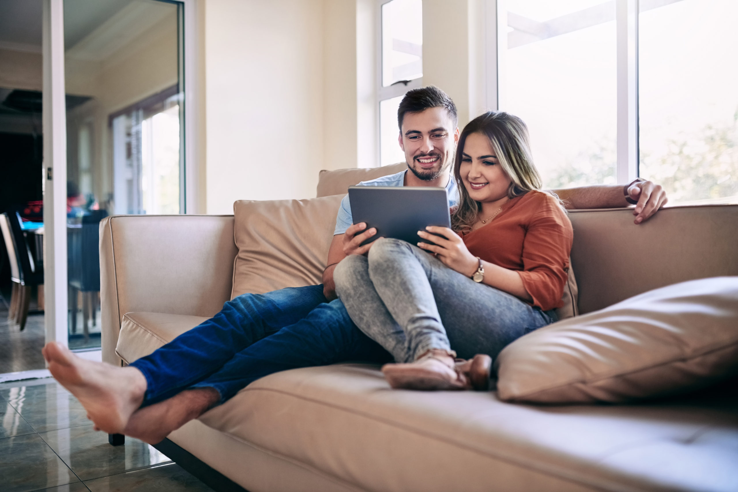 Shot of a young couple using a digital tablet together at home
