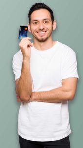Smiling man holding credit card
