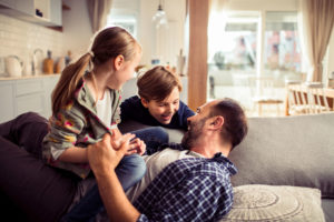 Close up of a father playing with his kids