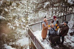 Close up of a group of seniors having hot tea while enjoying time together on the porch during winter
