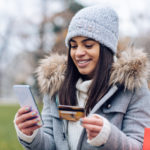 Young woman shopping online outdoors