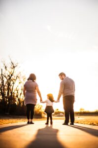 Family Standing Outdoors During Golden Hour