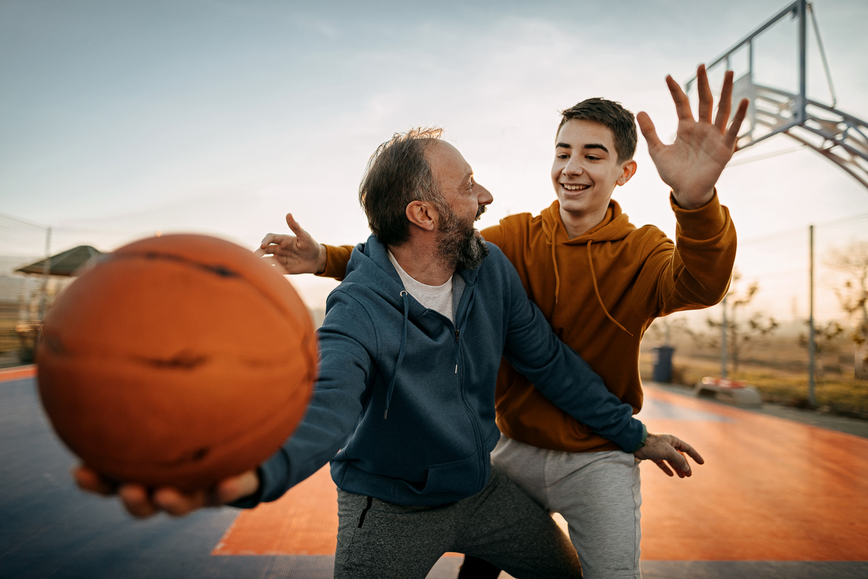 Father playing basketball with his son