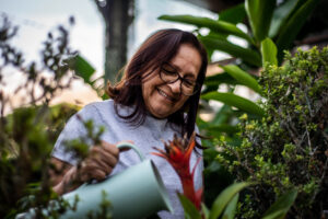 Elderly senior woman taking care of the garden