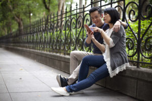 Happy Asian young couple have video conferencing at city park Taipei