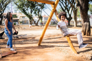 Happy boy playing in a swing