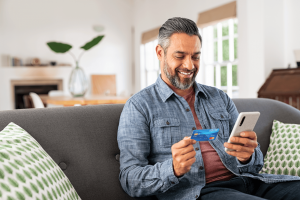 Man Holding UNCLE Debit Card