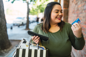 Woman Holding UNCLE Debit Card