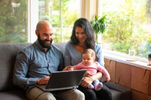 Couple going over home finances with a newborn