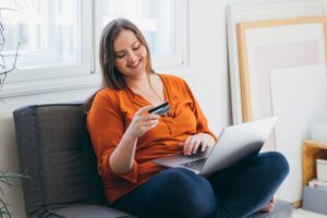 Smiling Woman Shopping Online Using her Laptop