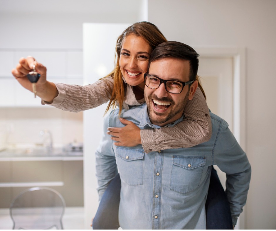 Couple Showing Keys To New Home