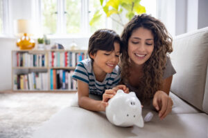 Mother And Son Braking Their Piggybank