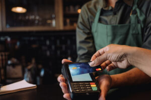 Someone making a tap to pay payment with their credit card.