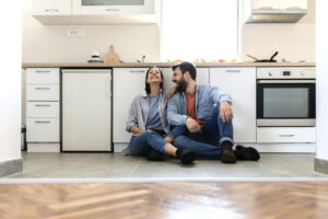 Couple at Home. Attractive Young Woman and Handsome Man Are Enjoying Spending Time Together in Light Modern Kitchen.