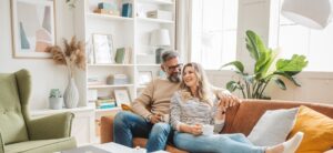 Mature couple at home, spending relaxed day together on couch.