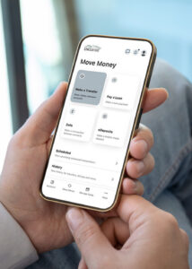 Person holding phone in hand on the Move Money transfer screen within UNCLE Digital Banking