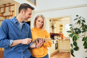 Adult couple at home with digital tablet