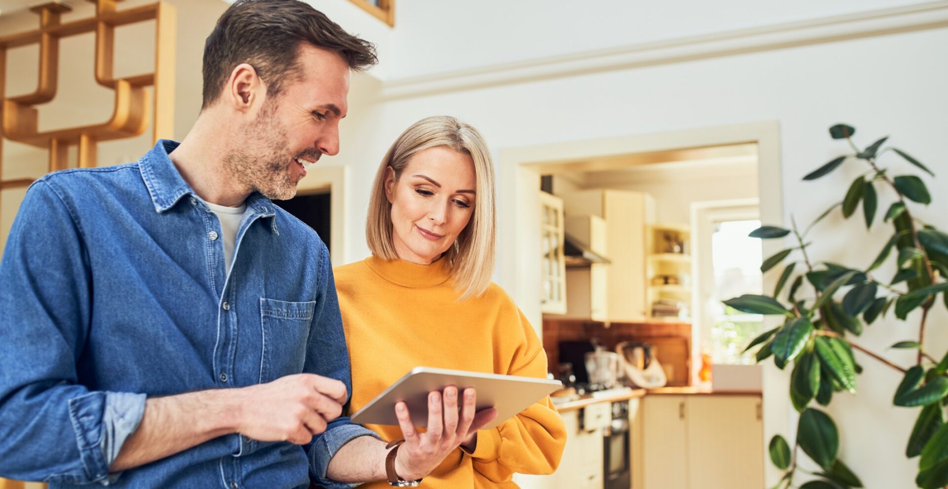 Adult couple at home with digital tablet