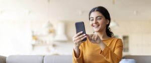 Woman at home using her smartphone