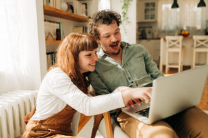 Young Couple Browsing Together on a Laptop at Home