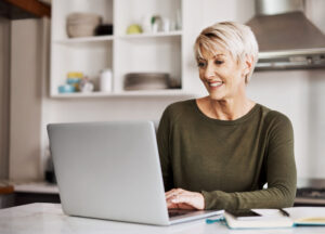 Shot of a mature woman working on a laptop at home