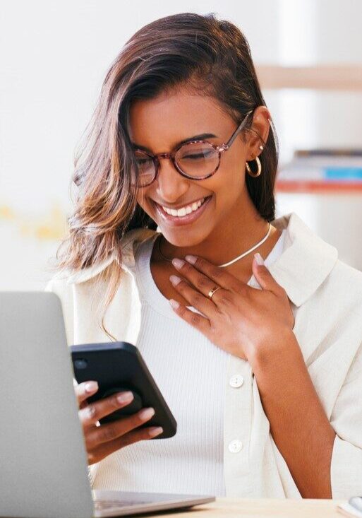 Excited woman, laptop and phone for home success